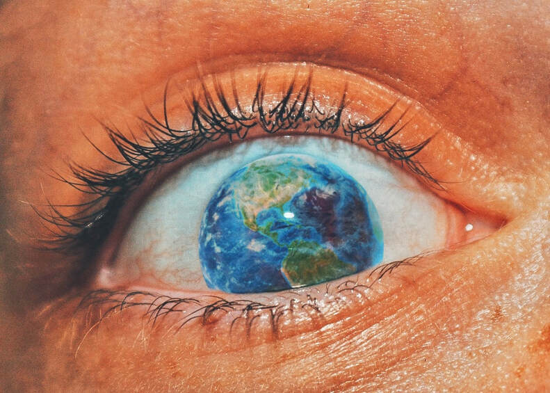 Close-up photograph of eye with planet Earth replacing the iris